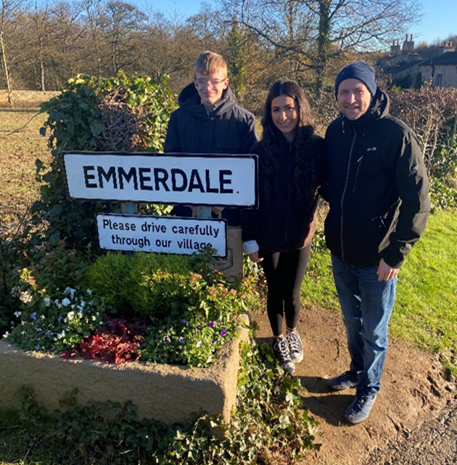 Young Person with Emmerdale Sign