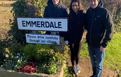 Young Person with Emmerdale Sign